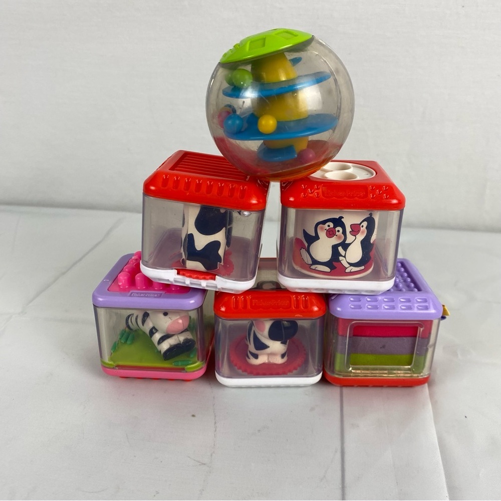 5 Fisher-Price Peek A Boo Blocks and I Bright Starts Rolling Ball.